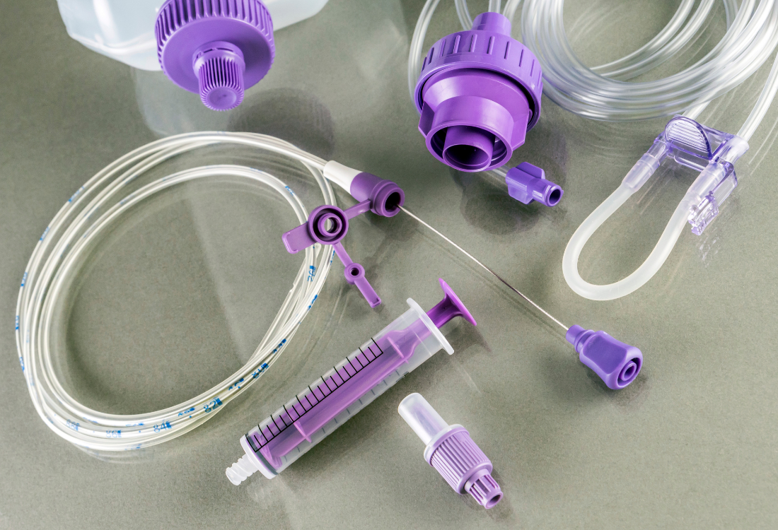 Close-up of medical-grade plastic components used in enteral feeding systems, featuring precision-moulded connectors and tubing that exemplify the importance of advanced plastic welding solutions in the medical sector.